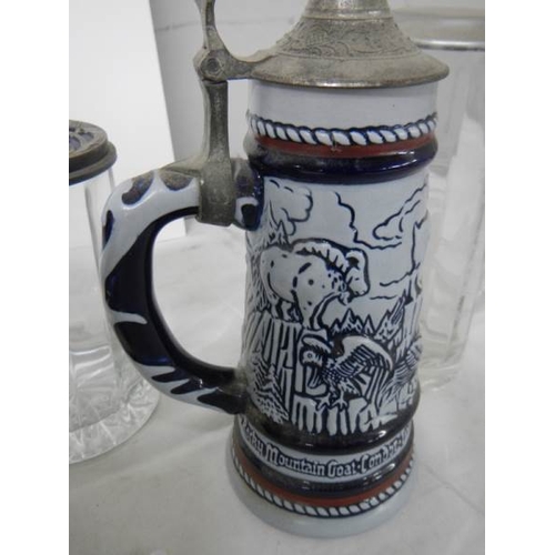 578 - Three glass beer steins and 2 Avon pottery beer steins.