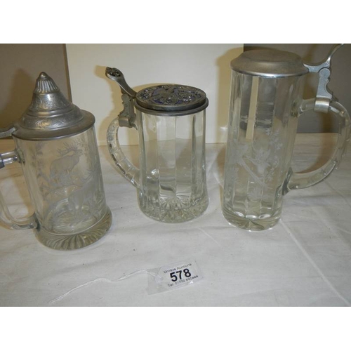 578 - Three glass beer steins and 2 Avon pottery beer steins.