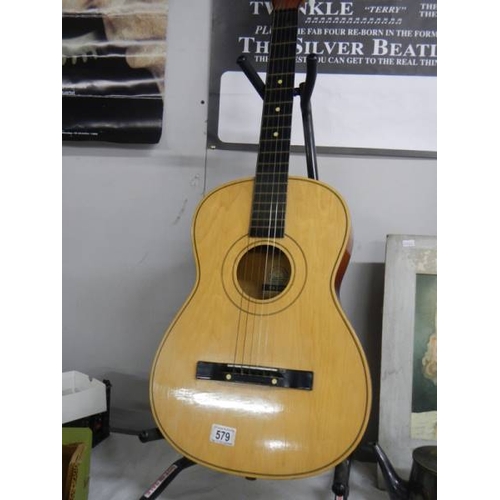 579 - A six string acoustic guitar.