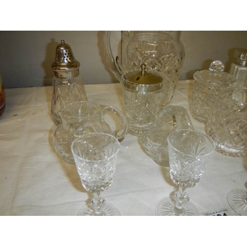 581 - A good lot of but glass including candlesticks, sugar sifters, jam pots, jugs etc., (14 items).