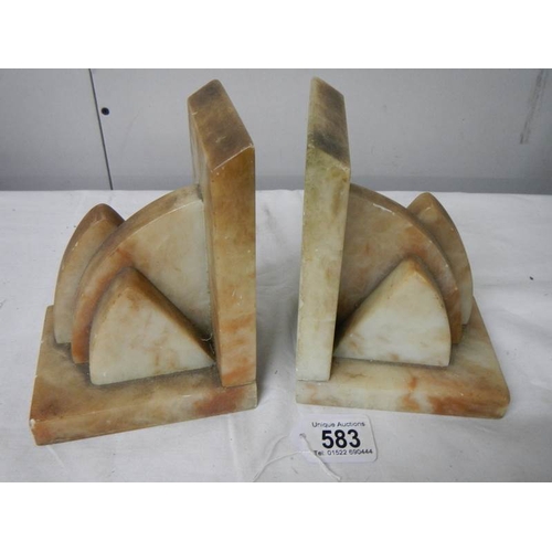 583 - A pair of marble book ends in good condition,.