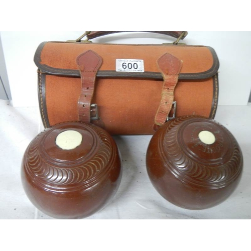 600 - A cased pair of vintage lawn bowls.