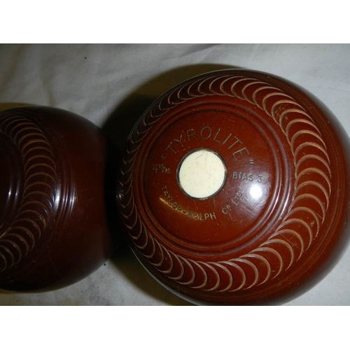 600 - A cased pair of vintage lawn bowls.