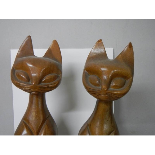 602 - A pair of tall wooden cat figures.