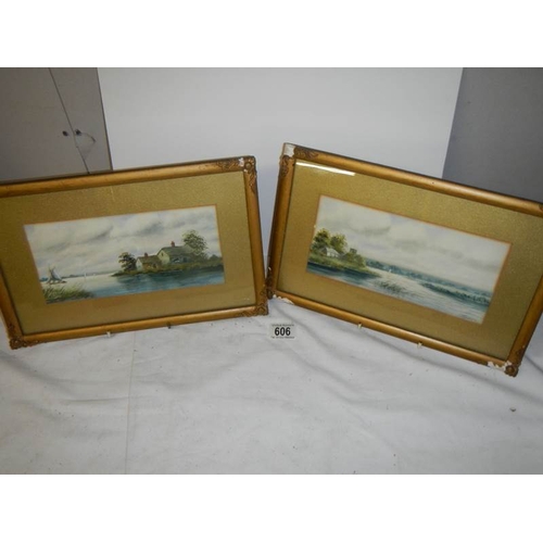 606 - A pair of framed and glazed rural scene watercolours signed  S Russell.