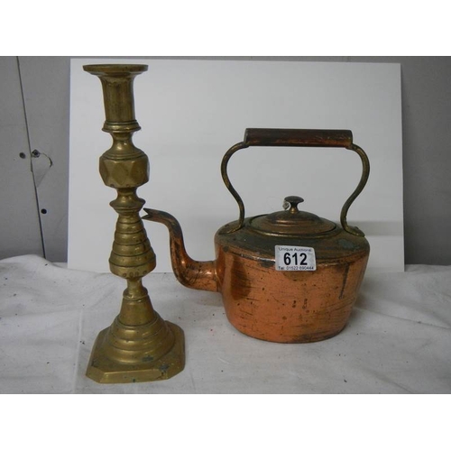 612 - A Victorian copper kettle and a brass candlestick.