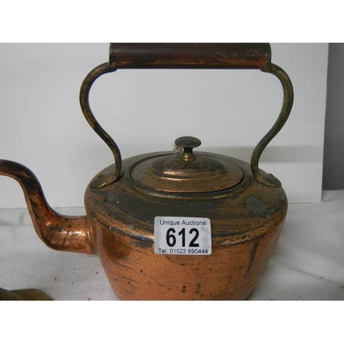 612 - A Victorian copper kettle and a brass candlestick.