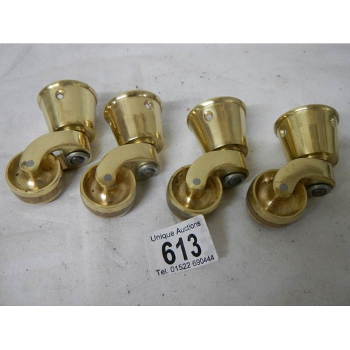 613 - A set of 4 new brass table casters, internal diameter of cup 3.5 cm.