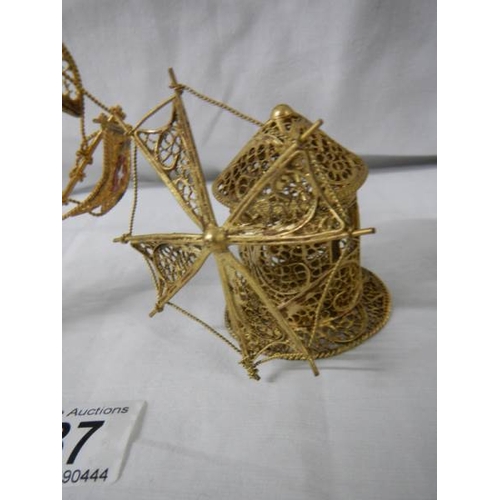 637 - A gold coloured wire model of a sailing ship and a windmill.