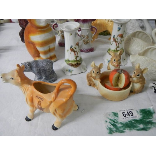 649 - 22 ceramic items including bisque swans, candlesticks etc.,