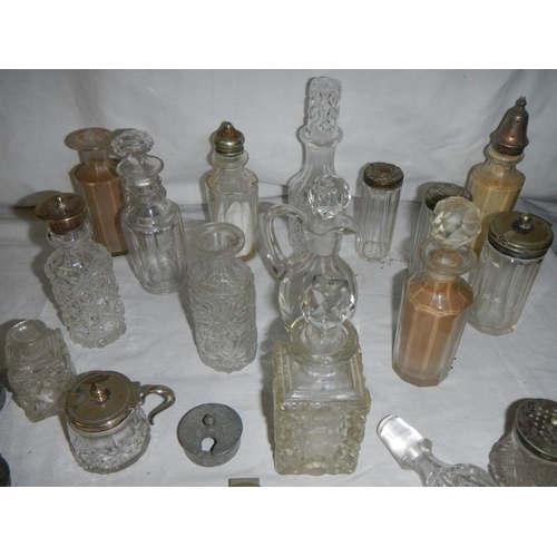 655 - A mixed lot of cruet bottles, inkwell tops, cruet tops etc.,