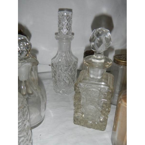 655 - A mixed lot of cruet bottles, inkwell tops, cruet tops etc.,