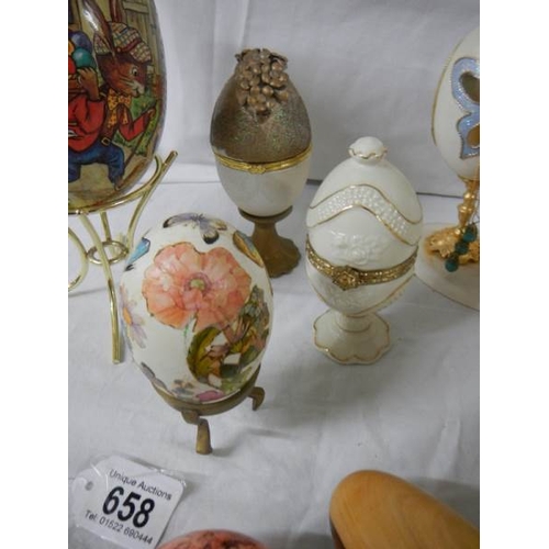 658 - A mixed lot of decorative collector's eggs in china and other materials.