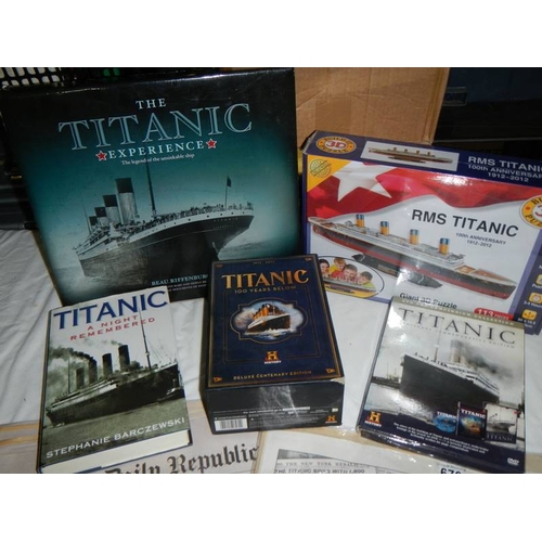 676 - A mixed lot of Titanic items, jigsaw puzzle, newspapers, book etc.,