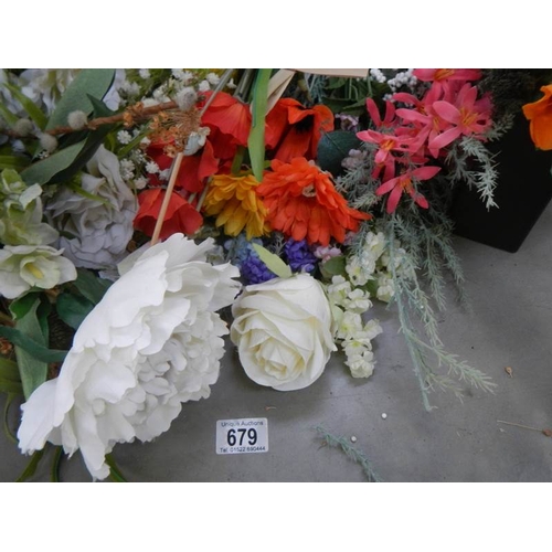 679 - A quantity of artificial flowers, some with vases.