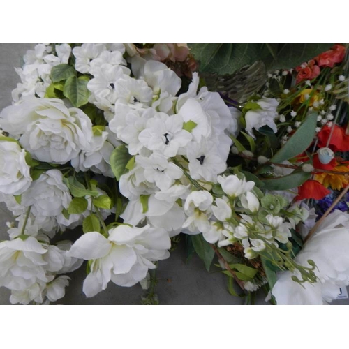 679 - A quantity of artificial flowers, some with vases.