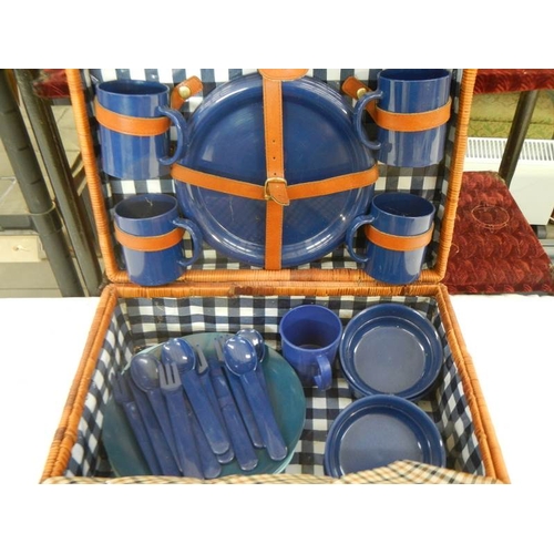 687 - A picnic basket with contents and cutlery.