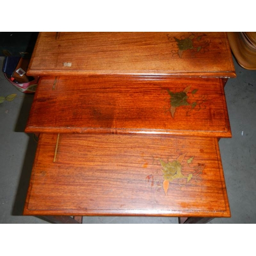 689 - A good nest of 3 teak inlaid tables.