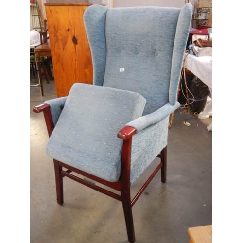 695 - A good quality wing armchair with automatic lifting mechanism.