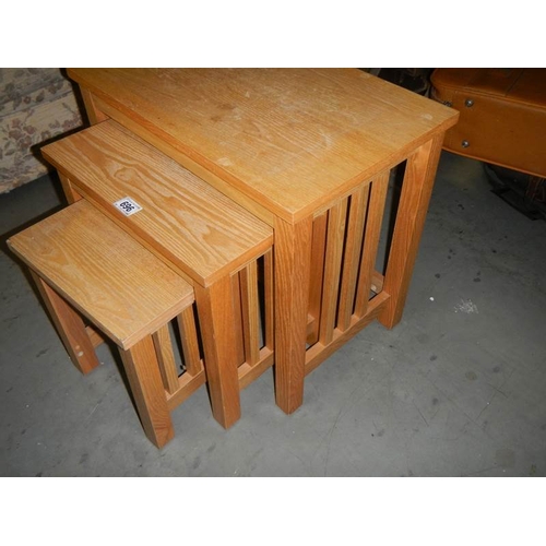 696 - A good nest of 3 oak tables.