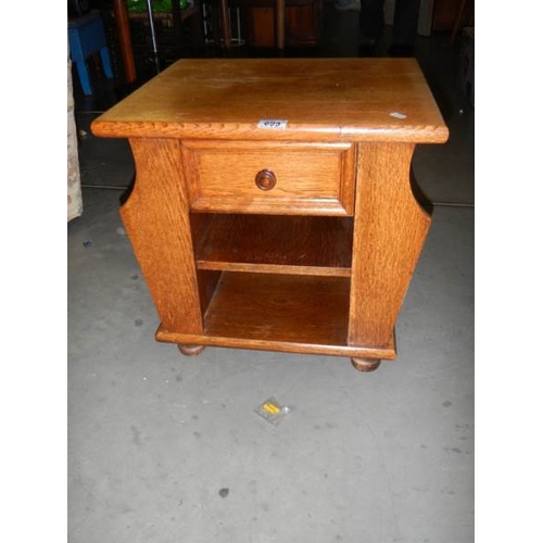 699 - A good oak magazine rack with drawer.