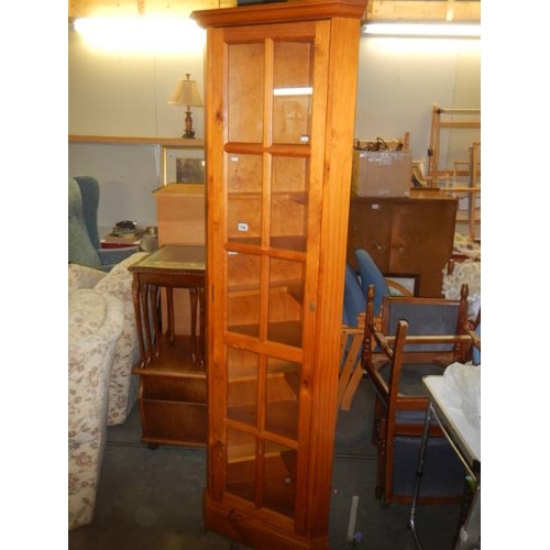 706 - A tall modern pine corner cabinet in excellent condition.