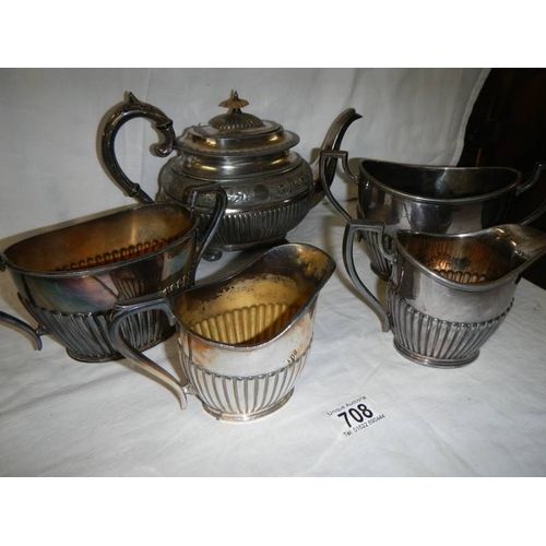 708 - A pewter teapot, 2 sugar bowls and 2 milk jugs.