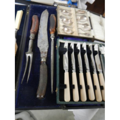 712 - 8 boxed sets of assorted cutlery including spoons, carving knives, silver handled set etc.,