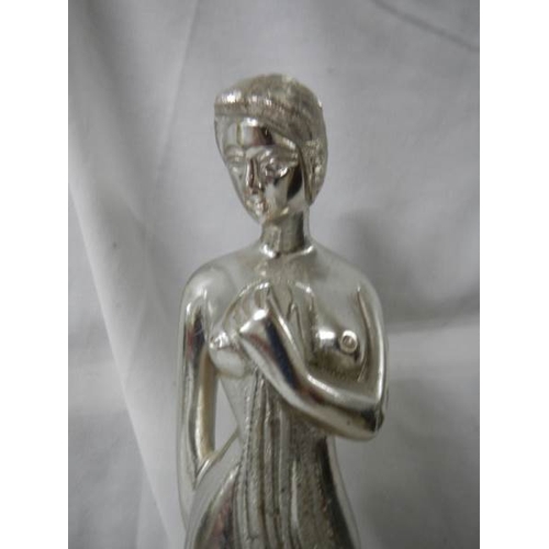 739 - A metal figure of a lady, 32 cm tall.