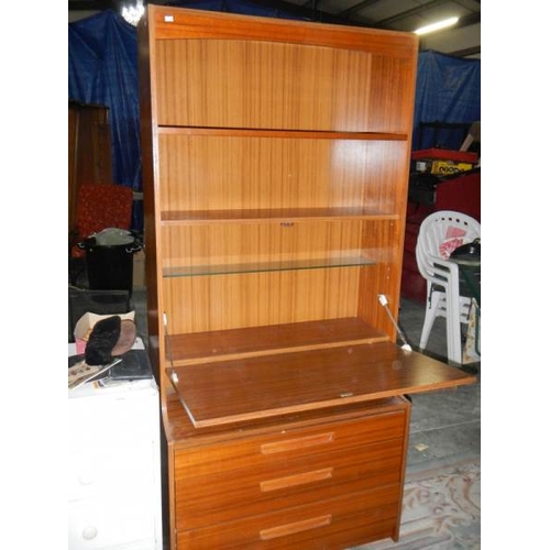 806 - A retro style wall unit with 3 drawers, 2 shelves and drop down front.