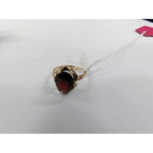 11 - A garnet ring in a oval setting hall marked for Birmingham 1971. Size O.