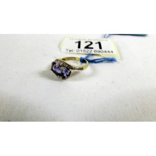 121 - A Tanzanite and diamond ring in a twist design, size L.