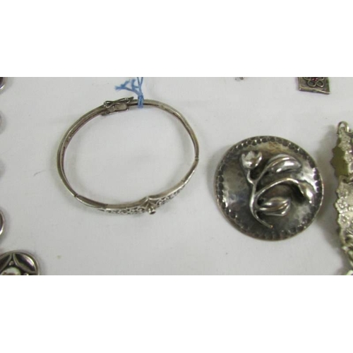 122 - A silver fob watch, a silver bangle and further jewellery items.