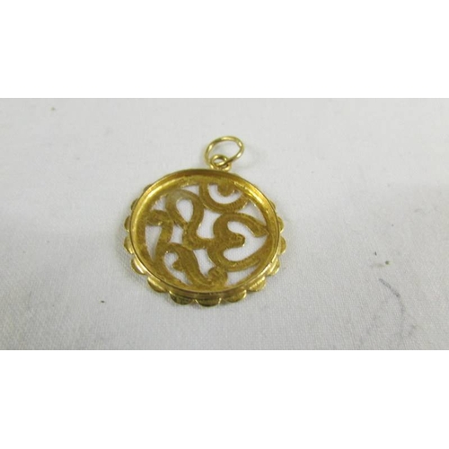 125 - A pendant (test and 24 ct gold) 2.6 grams.