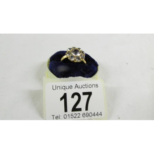 127 - A cluster ring size O, (tests as 24ct gold).