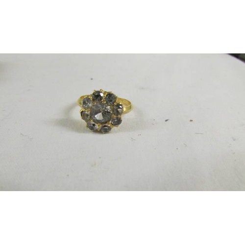 127 - A cluster ring size O, (tests as 24ct gold).
