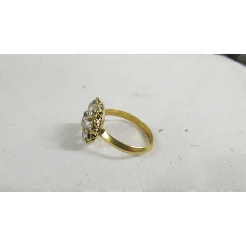 127 - A cluster ring size O, (tests as 24ct gold).
