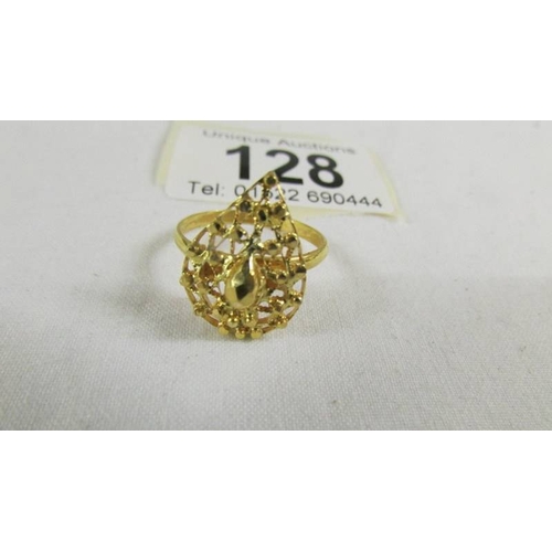 128 - A fretwork ring, size N half, (tests a 24ct gold), 3.5 grams.