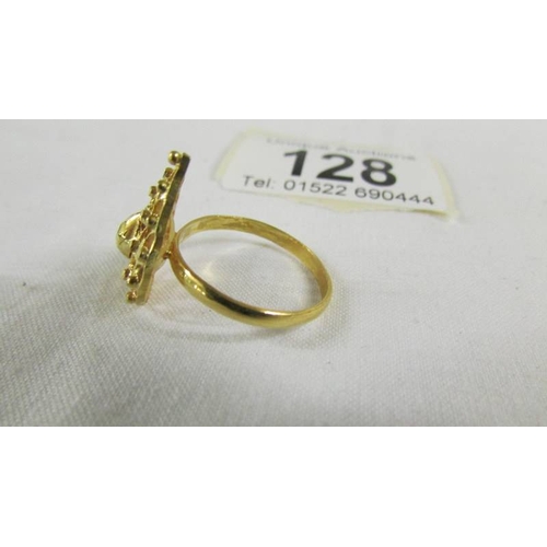 128 - A fretwork ring, size N half, (tests a 24ct gold), 3.5 grams.