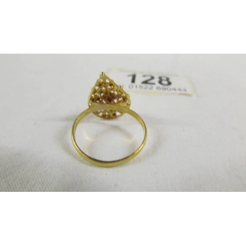 128 - A fretwork ring, size N half, (tests a 24ct gold), 3.5 grams.
