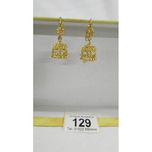 129 - A pair of pendant earrings, (test as 24 ct gold) 8.8 grams.
