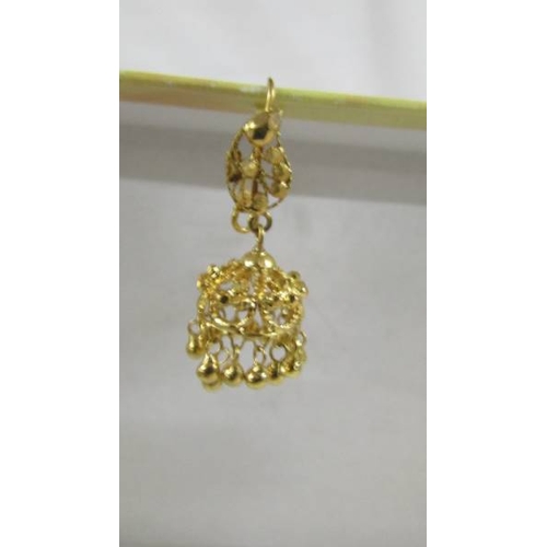 129 - A pair of pendant earrings, (test as 24 ct gold) 8.8 grams.