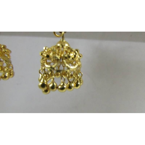 129 - A pair of pendant earrings, (test as 24 ct gold) 8.8 grams.
