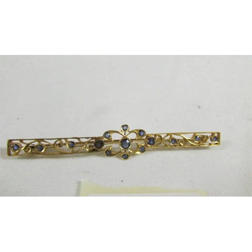 130 - A stone set brooch.  ( tests as 24ct gold).