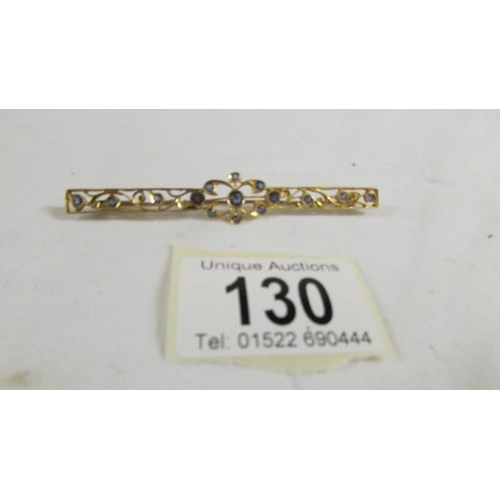 130 - A stone set brooch.  ( tests as 24ct gold).