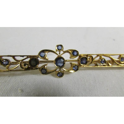 130 - A stone set brooch.  ( tests as 24ct gold).