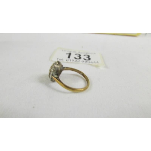 133 - A 9ct gold cluster ring, size K half.