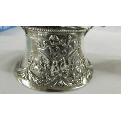 144 - A heavily embossed continental silver cream jug and sugar bowl, marked 800.