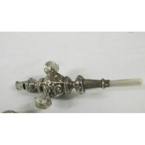 149 - A silver 1906 babies rattle/teether and a silver plate rattle as a policeman.