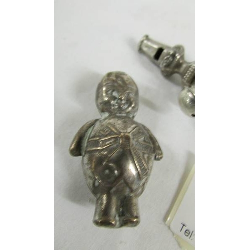 149 - A silver 1906 babies rattle/teether and a silver plate rattle as a policeman.